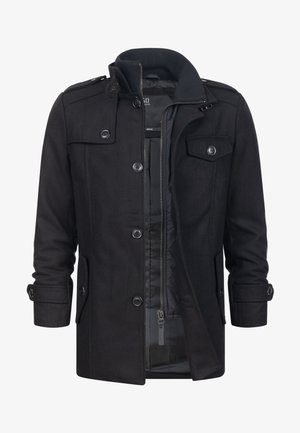 Black coat featuring a buttoned front, side pockets, and a zippered inner lining. Made from a smooth fabric with a tailored silhouette.