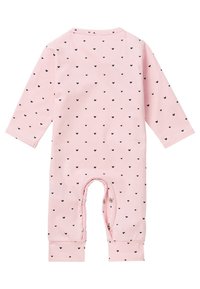 Light pink long-sleeve romper featuring small black heart patterns, a round neckline, and snap closures at the bottom for easy dressing.