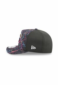 Black cap with multicolored splatter pattern. Features a solid black back, a flat brim, and a white logo on the side. Perforated texture.