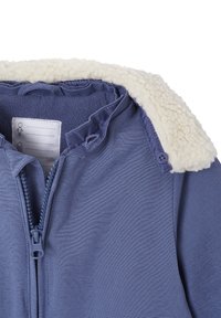 Blue jacket with a fuzzy cream collar, featuring a front zipper and button accents. Made from soft fabric with visible textured weave.