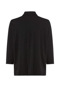 Schwarz langärmliges Hemd mit einem zentralen Rückenschlitz und einem hohen Kragen, auf einem weißen Hintergrund präsentiert.