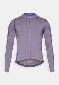 Jersey de ciclismo de manga larga en lavanda con cremallera frontal, dobladillo trasero extendido y detalles de costura en contraste. Tejido suave y transpirable.