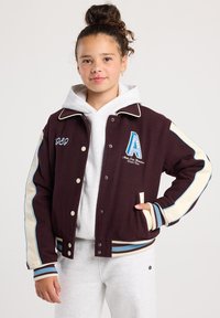 Maroon varsity jacket with cream and blue accents. Features embroidered letter "A" and numbers; buttons down the front; ribbed cuffs and hem.