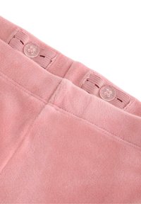 Světle růžové flísové kalhoty s jemnou texturou, které mají pas s dvěma průhlednými knoflíky a elastickými detaily pro bezpečné nošení.