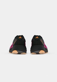 Fekete és rózsaszín Adidas Adizero futócipő pár hátulról nézve, síma fehér háttér előtt.