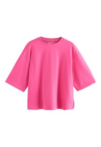 Klart rosa oversized t-shirt med korta ärmar, rund halsringning och sidospjäll, visas på vit bakgrund.