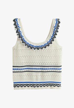 Tamborēts krēmkrāsas bezapkakles tops ar viļņotu izgriezumu un apakšmali, rotāts ar ziliem un melniem zigzaga un svītru rakstiem.