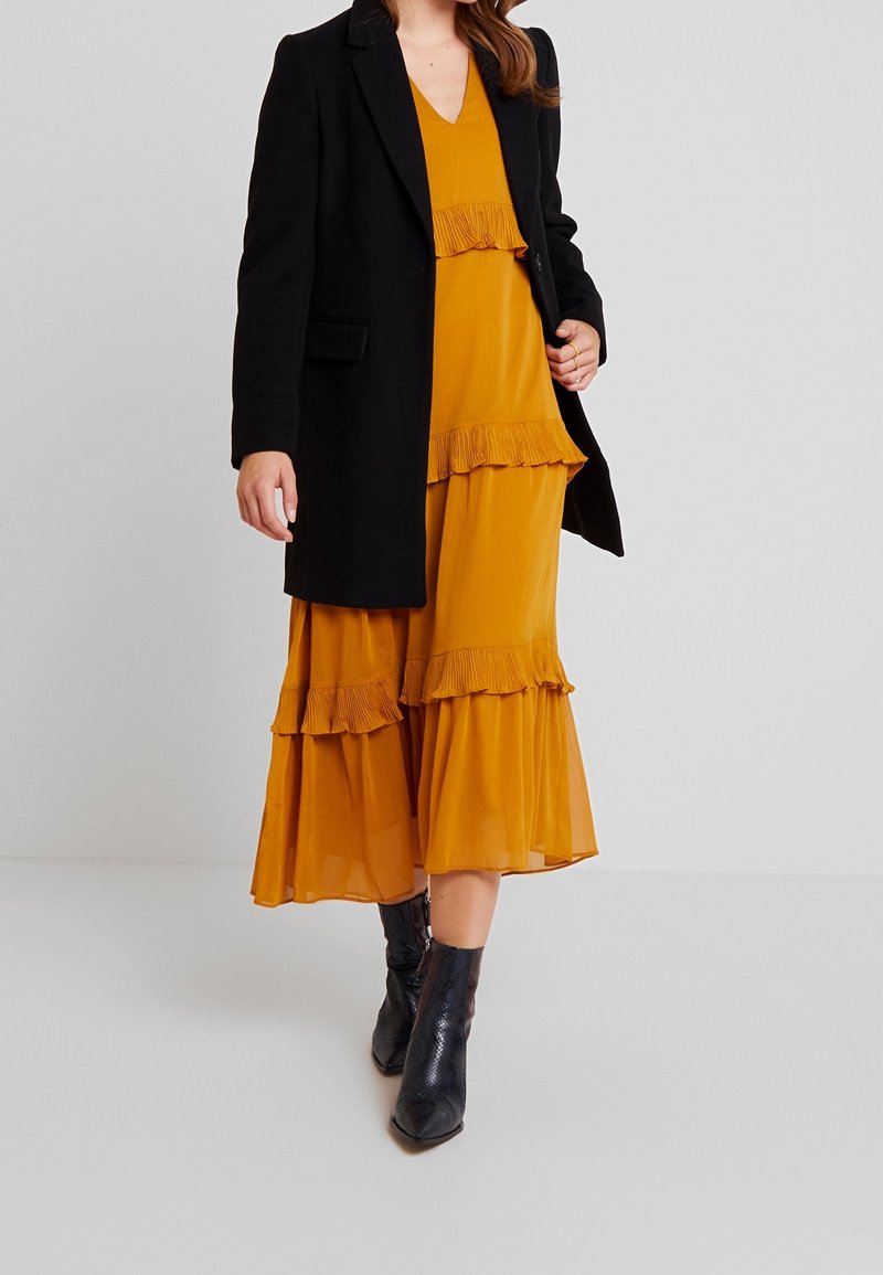 mustard dress with brown boots Annie romper – Tomboyts main image 0