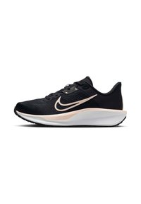 Musta urheilukenkä, jossa on teksturoitu päällinen, valkoinen välipohja ja vaaleanpunainen swoosh sivussa. Kevyt muotoilu mustalla pohjalla.