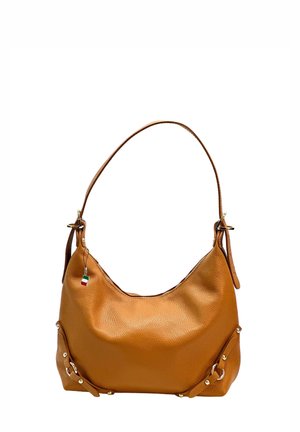Tan leather shoulder bag with gold-tone studs and a small Italian flag charm on a single strap against a white background.