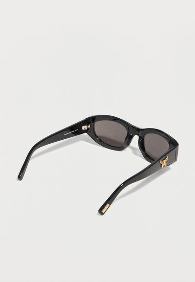 Black rectangular sunglasses with dark lenses, gold logo on temples, shown from a slightly tilted rear angle on a white background.