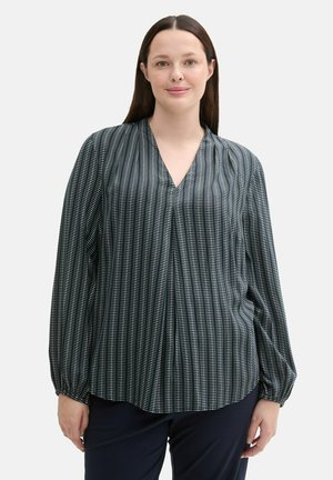 Blusa oscura con un patrón de rayas verticales en blanco, escote en forma de V, mangas largas con puños fruncidos y un corte holgado.