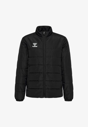 Two children wear black puffer jackets, one with black pants and shoes, the other with gray sweatpants and white sneakers, standing against a plain background.