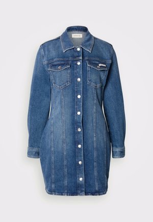 Denim haljina košulja u tamnoplavoj boji. Ima duge rukave, klasičan ovratnik, dva džepa na prsima i dugmad sprijeda. Naglašeni su okomiti šavovi.