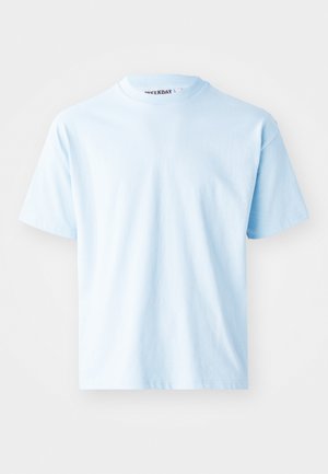 Light blue cotton t-shirt with short sleeves, round neckline, and minimal seams. The label "WEEKDAY" is visible at the neck.