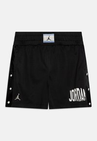 Black mesh shorts with an elastic waistband, white "JORDAN" print, and silver logo. Features snap button detailing on sides. Textured fabric.