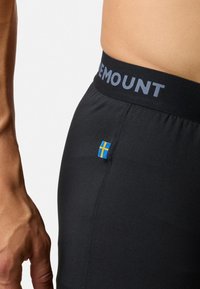 Black elastic shorts with a wide waistband featuring "MOUNT" text. A small blue and yellow flag accent is visible on the side.