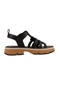 Sandalias negras con tiras y una plataforma gruesa marrón, con una suela texturizada y una franja blanca, diseñadas para durabilidad y comodidad.