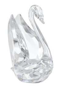 Statuina di cigno in cristallo trasparente con superficie sfaccettata, collo allungato e corpo arrotondato. Riflette la luce, mettendo in risalto angoli netti e curve morbide.
