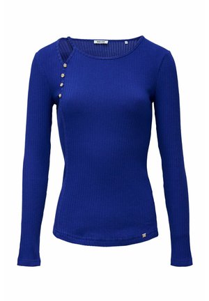 Top azul real de manga larga con textura acanalada, cuello redondo y cuatro botones decorativos a lo largo de la abertura del hombro izquierdo.