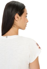 Weißes T-Shirt mit kurzen Ärmeln und gemusterten Akzenten an den Schultern sowie einem grauen Streifen am Rücken. Weicher, leichter Stoff.