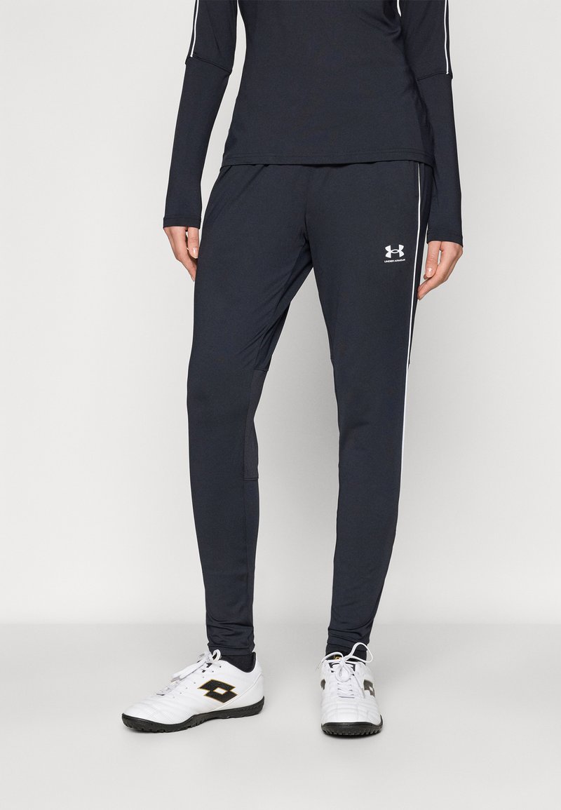 Námořnické sportovní kalhoty vyrobené z pružného materiálu, s bílými bočními pruhy, přiléhavým střihem a logem Under Armour na bocích.
