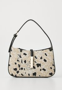 Vegan leather handbag with a beige and black spotted pattern, featuring a black strap and a gold accent in the center. Smooth texture.