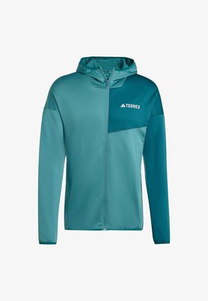 Tealová kapucňová bunda Terrex s předním zipem, texturovanou tkaninou a kontrastním panelem s bílým logem na hrudi.