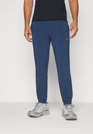 Navy blue pants made of lightweight, stretch fabric with an elastic waistband and adjustable cuffs. Features a subtle logo on the left leg.