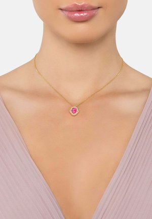 Gold chain necklace featuring a floral pendant with a central pink stone, surrounded by smaller clear stones and a textured gold outline.