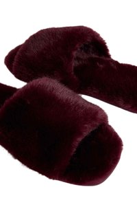 Burgundy faux fur slippers with open backs and wide straps, featuring a soft, fluffy texture and a flat, lightweight sole.