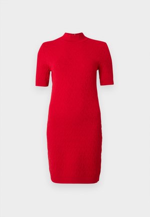 Punane kudumkleit kõrge krae ja lühikeste varrukatega. Omaduseks on tekstuuriga muster ja kitsas lõige, ulatudes üle põlve.