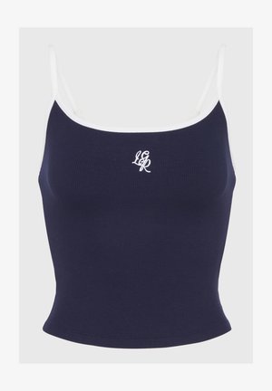 Marineblå ribbet crop top med hvide stropper og broderet logo. Har et tætsiddende design og en glat tekstur, der er egnet til afslappet brug.
