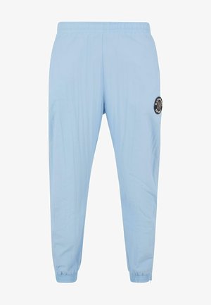Svijetloplave atletske hlače s elastičnim strukom, suženim krojem i crnim kružnim logotipom na lijevom bedru. Glatka tekstura.