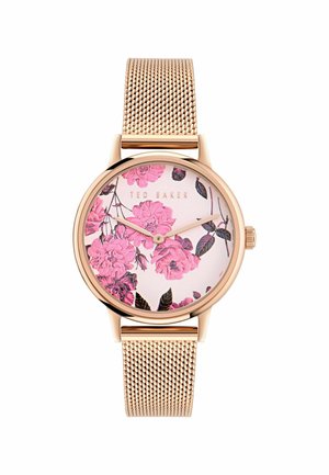 Runde Uhr mit einem roségoldenen Mesh-Armband. Zifferblatt mit floralem Muster, das pinke Blumen auf einem hellen Hintergrund zeigt. Markenname angezeigt.