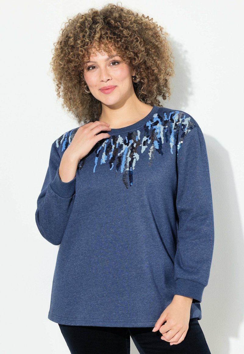 Sweatshirt bleu à manches longues et col rond, orné d'un motif abstrait en sequins bleu, noir et argent.