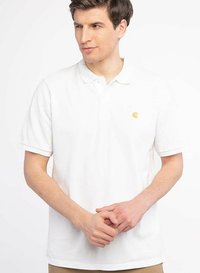 White polo shirt made of cotton with a classic collar, short sleeves, and a small yellow logo on the left chest. Smooth texture.