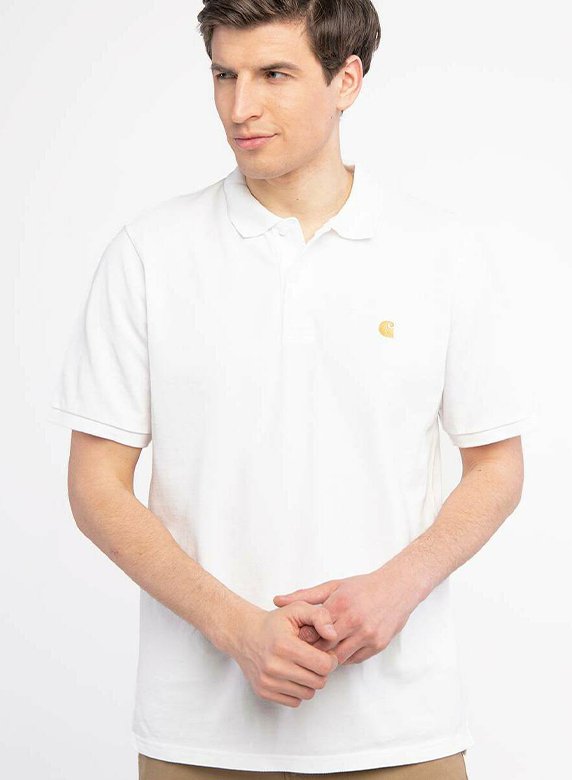 White polo shirt made of cotton with a classic collar, short sleeves, and a small yellow logo on the left chest. Smooth texture.