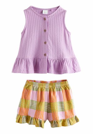 Sleeveless lavender buttoned top with ruffle hem paired with orange, green, and pink plaid elastic waist shorts with ruffled edges.
