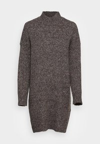 Maglione a collo alto lavorato a maglia di colore marrone scuro con spruzzi di colore. Maniche lunghe, vestibilità ampia e finituraTexture. L'orlo cade sotto i fianchi.
