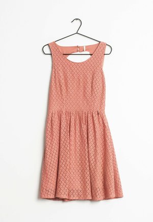 Abito color pesca con motivo a diamante testurizzato, corpo aderente e gonna svasata. Presenta una scollatura ampia e schiena scoperta con chiusura a clip.