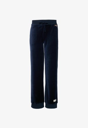 Pantalones de terciopelo azul marino con cintura elástica, cordón ajustable, puños acanalados, pequeño detalle de lazo beige y etiqueta blanca cerca del dobladillo.