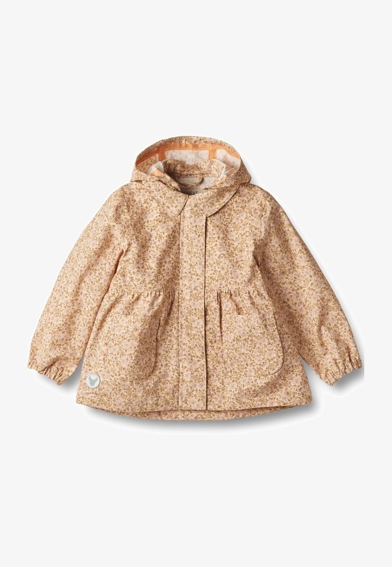 Imperméable beige à capuche pour enfants avec petit motif floral, deux poches avant, poignets élastiques et un patch réfléchissant en forme de cœur près de l'ourlet.
