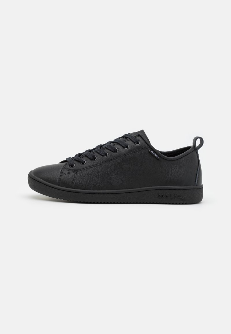 Black sneakers with a smooth leather upper, rounded toe, tonal laces, and a textured rubber sole. Includes a small pull tab at the heel.