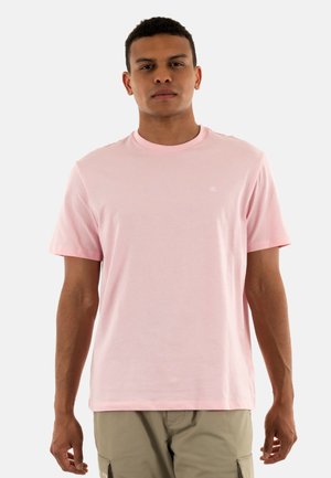 Camiseta de manga corta rosa claro en un suave tejido de algodón, con cuello redondo, una mínima marca en el pecho y un corte holgado.
