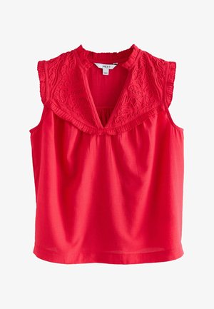 Punane varrukateta pluus tekstuurse kangaga, millel on kaelusel tikitud detailid ja kogutud taljega disain.