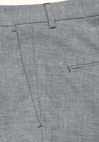 Grå, teksturerede stofbukser med linning med bæltestropper og en enkelt baglomme. Bemærkelsesværdig syning og skræddersyede designdetaljer.