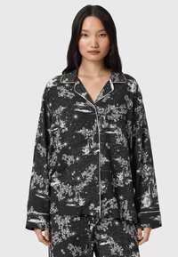 Czarny zestaw piżam bawełnianych z białym wzorem niebieskim. Posiada kołnierz o kroju szpiczastym, guziki oraz kontrastowe białe obszycia na brzegach.