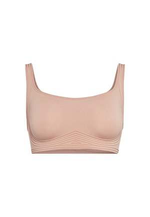 Nude-kleurige bh met een gladde textuur, brede schouderbanden en een naadloos ontwerp. Heeft subtiele ribbels langs de onderste band.