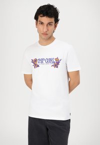 White cotton t-shirt features a colorful floral graphic print in purple and orange, with round neckline and short sleeves.